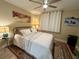 Comfortable bedroom with ceiling fan, decorative art, and patterned area rug at 3272 Lake Bayshore Dr # 515, Bradenton, FL 34205