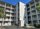 Exterior of building 3036-3292 with balconies and well-maintained grounds at 3272 Lake Bayshore Dr # 515, Bradenton, FL 34205