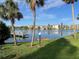 Scenic lake view with a pier, palm trees, and manicured lawn creating a tranquil and inviting community atmosphere at 3272 Lake Bayshore Dr # 515, Bradenton, FL 34205