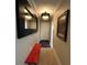 Bright entryway featuring a stylish mirror, chandelier, and a pop of color with a modern red bench at 3272 Lake Bayshore Dr # 515, Bradenton, FL 34205