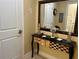 Hallway table with mirror, candle, and decorative artwork at 3272 Lake Bayshore Dr # 515, Bradenton, FL 34205