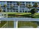 Condo exterior with a view of a serene pond and lush tropical landscaping at 3272 Lake Bayshore Dr # 515, Bradenton, FL 34205