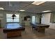 Game room with two covered pool tables and built-in storage cabinets at 3272 Lake Bayshore Dr # 515, Bradenton, FL 34205