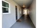 Well-lit hallway with neutral tones and clean lines leading to the unit's entrance at 3272 Lake Bayshore Dr # 515, Bradenton, FL 34205