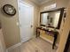 Hallway featuring a decorative table and mirror next to a white door at 3272 Lake Bayshore Dr # 515, Bradenton, FL 34205