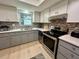 Well-lit kitchen showcasing stainless steel appliances, neutral cabinets, and sleek countertops at 3272 Lake Bayshore Dr # 515, Bradenton, FL 34205