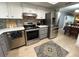 Contemporary kitchen features stainless steel appliances and stylish gray and white cabinetry at 3272 Lake Bayshore Dr # 515, Bradenton, FL 34205