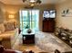 Inviting living room featuring a comfortable sofa, stylish rug, and sliding glass doors to a balcony at 3272 Lake Bayshore Dr # 515, Bradenton, FL 34205