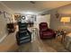 Open-concept living space with recliner chairs, light wood floors, and a glimpse into the adjacent dining area at 3272 Lake Bayshore Dr # 515, Bradenton, FL 34205