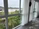 Bright living room featuring a large window with beautiful views and sheer white curtains at 3272 Lake Bayshore Dr # 515, Bradenton, FL 34205