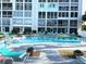 Community pool with an ample supply of lounge chairs for relaxing by the water at 3272 Lake Bayshore Dr # 515, Bradenton, FL 34205