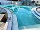 Community pool with clear blue water, well-maintained decking and marked depths for safety at 3272 Lake Bayshore Dr # 515, Bradenton, FL 34205