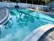 Long rectangular community pool surrounded by stone provides a relaxing water space at 3272 Lake Bayshore Dr # 515, Bradenton, FL 34205