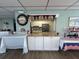 Serving area with a bar and a view into the kitchen area with decorations at 3272 Lake Bayshore Dr # 515, Bradenton, FL 34205