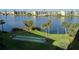Scenic view of shuffleboard courts overlooking a lake, surrounded by lush landscaping at 3272 Lake Bayshore Dr # 515, Bradenton, FL 34205