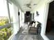 Relaxing sunroom with wicker furniture, ceiling fan, and community views at 3272 Lake Bayshore Dr # 515, Bradenton, FL 34205