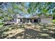 Backyard featuring home, screened in patio, deck, grass and mature shade trees at 3428 Mineola Dr, Sarasota, FL 34239