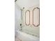 Clean white bathtub with tiled wall accents and updated fixtures at 3428 Mineola Dr, Sarasota, FL 34239