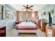 Comfortable bedroom featuring unique wall decor and a ceiling fan at 3428 Mineola Dr, Sarasota, FL 34239