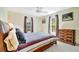 Bright bedroom with a ceiling fan, two windows, and carpeted floors at 3428 Mineola Dr, Sarasota, FL 34239