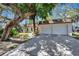 Inviting home with a two-car garage and a spacious driveway lined by mature landscaping at 3428 Mineola Dr, Sarasota, FL 34239