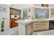 Bright kitchen with a breakfast bar, stainless steel sink, and ample natural light at 3428 Mineola Dr, Sarasota, FL 34239