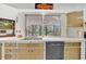 Kitchen with a stainless steel sink, modern dishwasher, and ample counter space at 3428 Mineola Dr, Sarasota, FL 34239