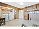 View of the laundry room featuring a washer, dryer, storage shelves and wood paneled walls at 3428 Mineola Dr, Sarasota, FL 34239