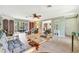 Bright living room featuring tile floors, light green walls, and a ceiling fan at 3428 Mineola Dr, Sarasota, FL 34239