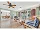 Inviting living room features tile floors, light green walls, and views into the dining area at 3428 Mineola Dr, Sarasota, FL 34239