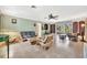 Spacious living room featuring tile floors, light green walls, and bamboo furniture at 3428 Mineola Dr, Sarasota, FL 34239