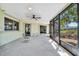 A screened-in patio area with ceiling fan, outdoor furniture, and views of the backyard at 3428 Mineola Dr, Sarasota, FL 34239