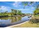 Scenic view of a tranquil waterway, lined with lush greenery and beautiful waterfront properties at 3428 Mineola Dr, Sarasota, FL 34239