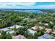 Panoramic aerial view showcasing the neighborhood with beautiful waterways and lush greenery, offering a serene coastal living experience at 3837 Camino Real, Sarasota, FL 34239