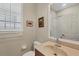 Bathroom featuring a sink vanity, toilet, and enclosed shower space at 3837 Camino Real, Sarasota, FL 34239