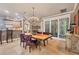 Elegant dining area with chandelier and view of the kitchen at 3837 Camino Real, Sarasota, FL 34239