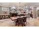 Dining area featuring a chandelier, fireplace, and open layout at 3837 Camino Real, Sarasota, FL 34239