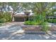Charming single Gathering home with a well-maintained lawn, beautiful landscaping, and a tile roof at 3837 Camino Real, Sarasota, FL 34239