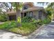 Beautiful home with a tile roof, lush landscaping, and a well-manicured lawn at 3837 Camino Real, Sarasota, FL 34239