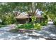 Charming single Gathering home with a well-maintained lawn, beautiful landscaping, and a tile roof at 3837 Camino Real, Sarasota, FL 34239