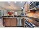 Updated kitchen with stainless steel appliances and granite countertops at 3837 Camino Real, Sarasota, FL 34239