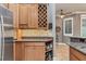 Kitchen with wooden cabinets, wine rack, and view into the dining area at 3837 Camino Real, Sarasota, FL 34239