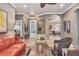 Comfortable living room featuring tile floors, neutral walls, and stylish furnishings at 3837 Camino Real, Sarasota, FL 34239