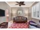 Cozy living room featuring a ceiling fan, decorative rug, and comfortable seating area at 3837 Camino Real, Sarasota, FL 34239