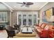 Spacious living area with tile flooring, neutral walls, and plenty of seating at 3837 Camino Real, Sarasota, FL 34239