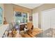 Bright office space with a desk, hardwood floors, and plenty of natural light at 3837 Camino Real, Sarasota, FL 34239