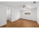 Empty bedroom featuring wood floors, a ceiling fan, and a window with a view of the backyard at 3975 Coleridge Pl, Sarasota, FL 34241
