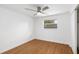 Bedroom features wood flooring, a ceiling fan, and a sunny window bringing in natural light at 3975 Coleridge Pl, Sarasota, FL 34241