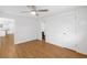 Bedroom with hardwood flooring, a ceiling fan, and a doorway to the bathroom at 3975 Coleridge Pl, Sarasota, FL 34241