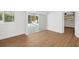 Bedroom featuring wood floors, access to a pool through sliding glass doors, and white walls at 3975 Coleridge Pl, Sarasota, FL 34241